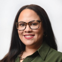 woman wearing glasses, smiling. 