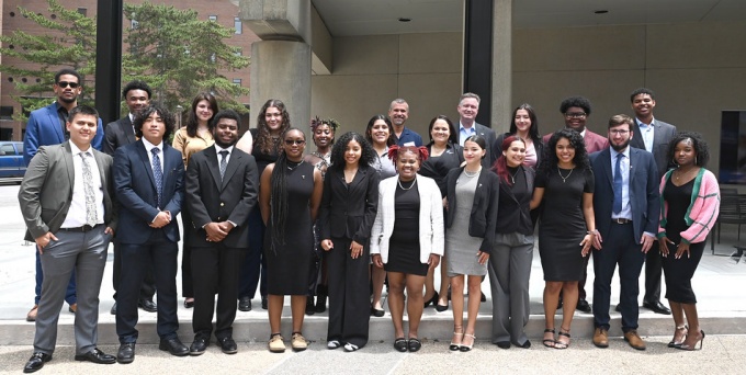 a group of young adults standing outside a building.