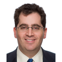 man wearing business suit and wearing glasses.