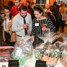 people looking over auction item.