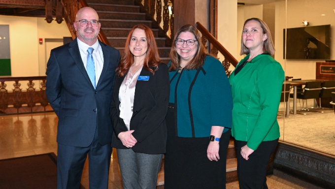 Group of people posing for a photo, smiling.