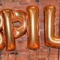 Balloons that spell BPILP. 