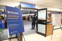 Doorway to library, signs outside the door welcoming attendees. 