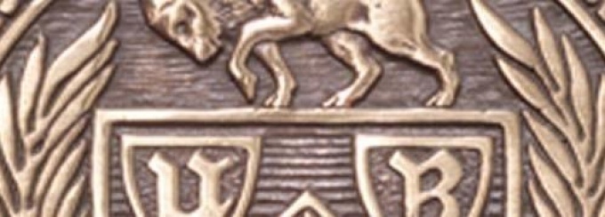 Closeup image of a bronze emblem. 