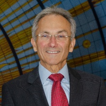 John Feroleto wearing red tie, dark grey jacket, light blue shirt.