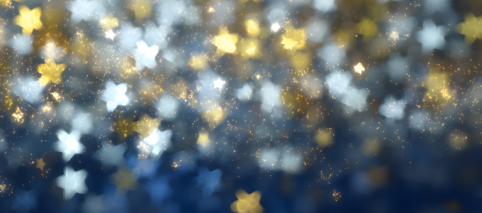 Blue hazy background with gold and silver stars and glitter.
