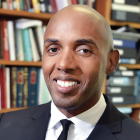 man, smiling, looking to his left.