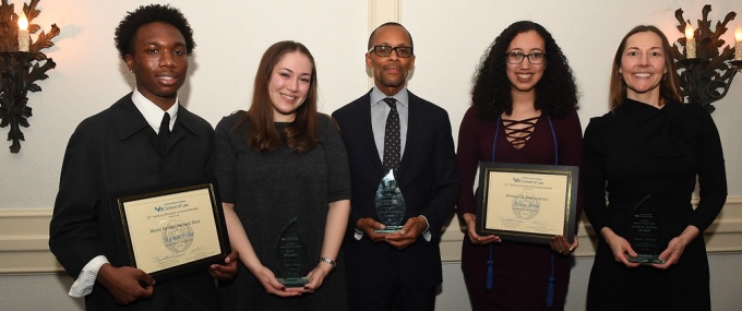 Group of individuals holding plaques. 