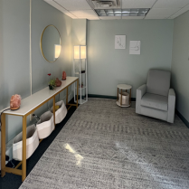 Zoom image: room with chair, shelves, grey rug, mirror on the wall