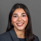 Sally Rosenthal wearing grey jacket, necklace.