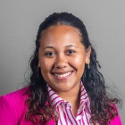 Tyonna Acoff wearing pink jacket, smiling.
