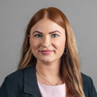 Cassidy Baden wearing grey jacket, smiling.