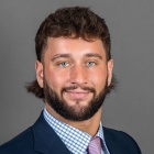 Jonathan Stevens wearing blue jacket, pink tie.