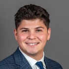 Carlo Cancellieri wearing blue striped suit, blue tie.