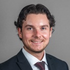 Sean Hannan wearing suit and tie, smiling.