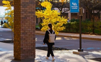 student walking outside O'Brian Hall. 