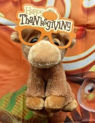 a photo a stuffed bull with thanksgiving glasses. 