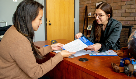 student talking to Admissions staff. 